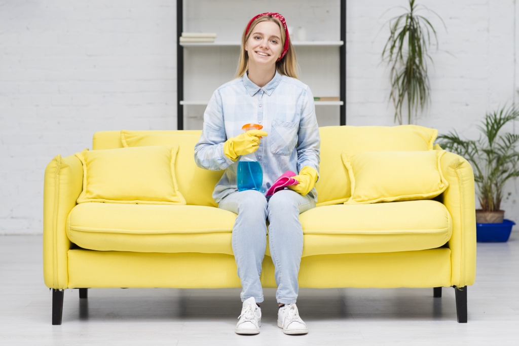 cleaning-woman-sitting-couch.jpg